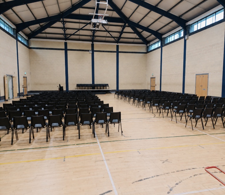Sports hall arranged with seating for an event